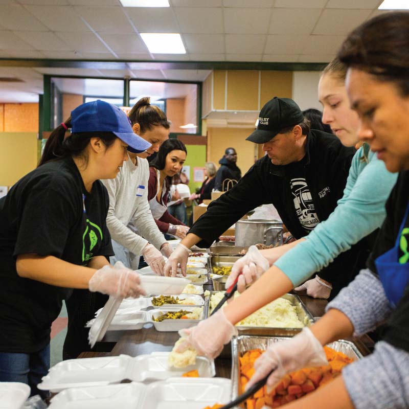 A group of people preparing food for those in need