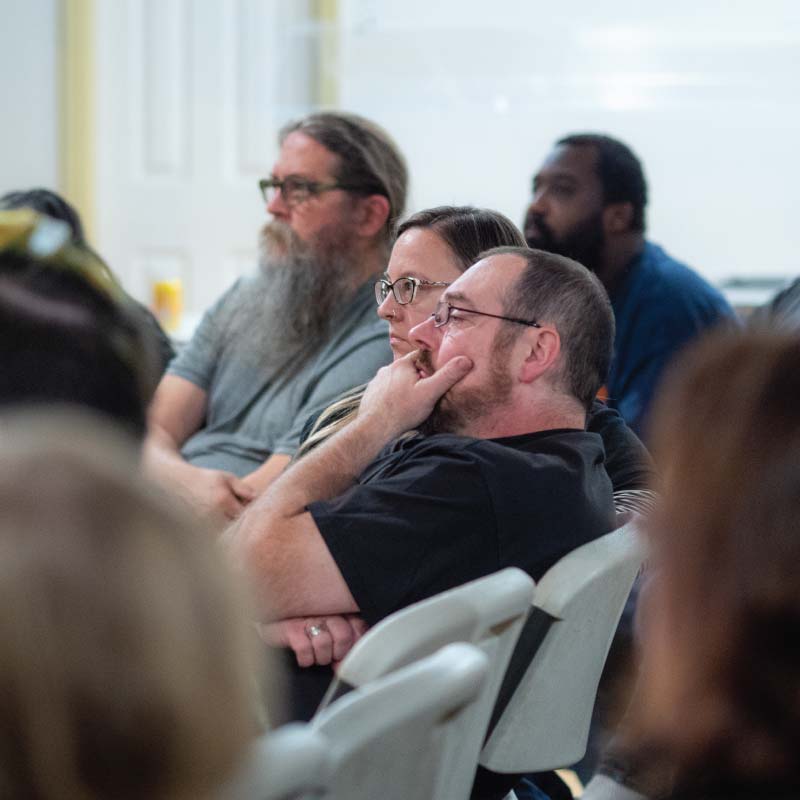 People sitting and listening to a teaching