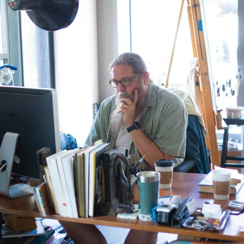 A person sitting at a desk working on a computer